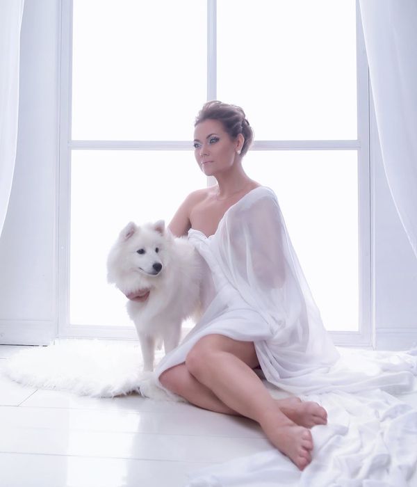 Woman with a calm and focused expression in a minimalist environment.